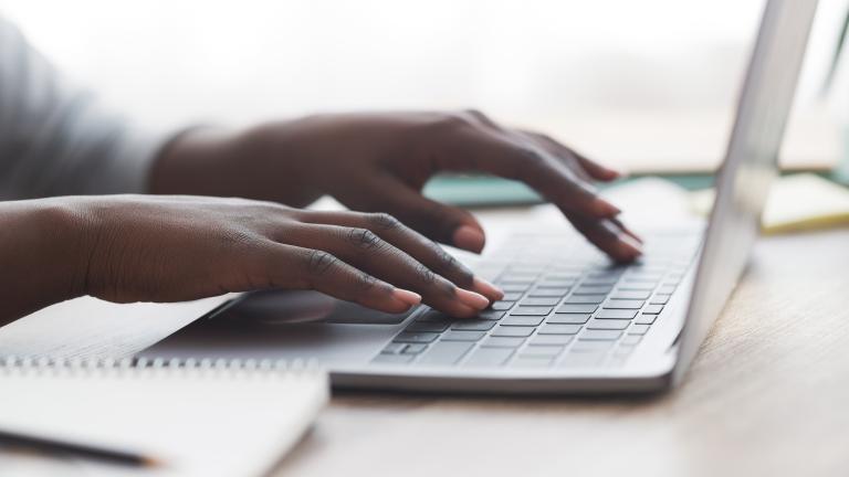 Hands typing on keyboard